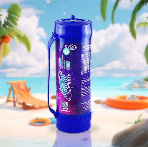 In the image, there is a large cream charger canister with a vibrant blue color, featuring a detailed design that includes cosmic and nebula-like patterns in purple and pink hues. The design integrates the "iSi" logo and appears to include some text and QR codes, likely providing product information and interactive content for consumers. The canister is equipped with a handle, suggesting its large size and utility. The backdrop is a serene beach setting with elements of a typical beach day—palm trees, a beach chair, a sun hat, a beach ball, and an orange life ring. The tranquil sea and blue sky with fluffy clouds add to the relaxed, holiday atmosphere. The visual contrasts the functional object with a scene of leisure and relaxation.