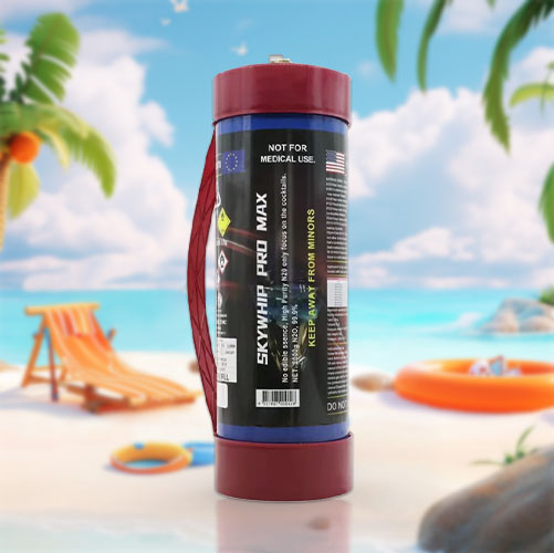 The image shows a cream charger, also known as a 'nang,' that has been superimposed onto a beach scene. The charger stands vertically, appearing disproportionately large compared to the surrounding beach items, suggesting a playful alteration of scale. It's placed on sand, with a clear blue sky in the background, flanked by a palm tree, a deck chair, a beach ball, and an inflatable ring, which add to the relaxed, vacation vibe of the setting. The juxtaposition of the cream charger in this context is whimsical and surreal.