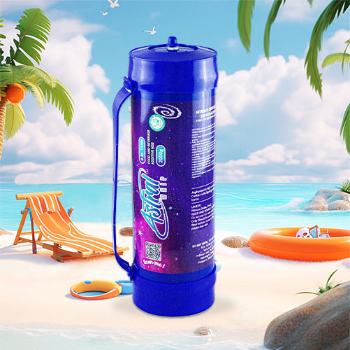 In the image, there is a large cream charger canister with a vibrant blue color, featuring a detailed design that includes cosmic and nebula-like patterns in purple and pink hues. The design integrates the "iSi" logo and appears to include some text and QR codes, likely providing product information and interactive content for consumers. The canister is equipped with a handle, suggesting its large size and utility. The backdrop is a serene beach setting with elements of a typical beach day—palm trees, a beach chair, a sun hat, a beach ball, and an orange life ring. The tranquil sea and blue sky with fluffy clouds add to the relaxed, holiday atmosphere. The visual contrasts the functional object with a scene of leisure and relaxation.