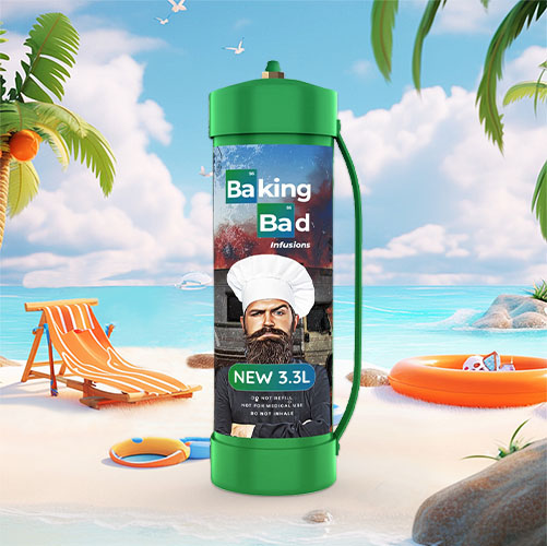 This image showcases an oversized cream charger canister on a beach setting, featuring a label "Baking Bad infusions" with an image of a character wearing a chef's hat and glasses. The canister is green and has an additional handle, indicating its substantial size. The label also states "NEW 3.3L," suggesting it is a large volume canister recently introduced to the market. The creative design is a clear play on words referencing a popular TV show. The background is a sunny beach scene with a lounge chair, a beach ball, a sun hat, an orange inflatable ring, palm trees, rocks, and the ocean, all under a clear blue sky. This whimsical imagery contrasts the culinary use of the cream charger with the leisure and relaxation associated with a beach holiday.
