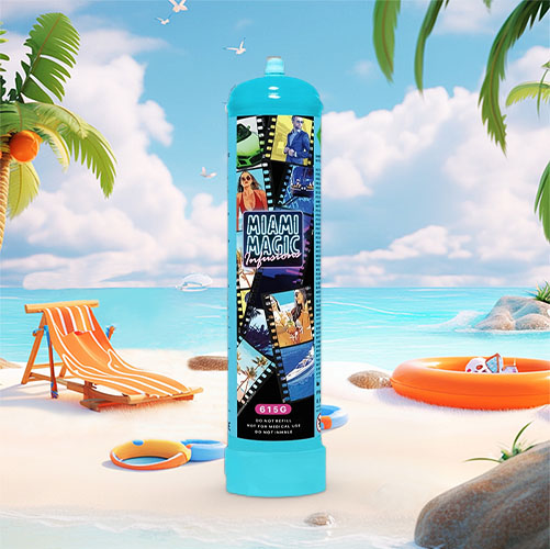 The image showcases an oversized cream charger canister with a lively "Miami Magic" themed wrap. The wrap features a collage of various scenes and characters that might be associated with Miami, including nightlife, music, and vibrant city life. The canister's bright turquoise color captures the essence of the ocean and the sky, which is also reflected in the beach setting surrounding it. The beach scene is complete with a sun chair, beach ball, sun hat, and an orange inflatable ring, situated among palm trees and overlooking a serene ocean landscape. The canister is marked with the net weight "615g" and is set in a playful and energetic context, suggesting a connection to fun and creativity in cooking. The entire setting invokes the excitement and glamour of Miami, contrasting with the peaceful beach backdrop.