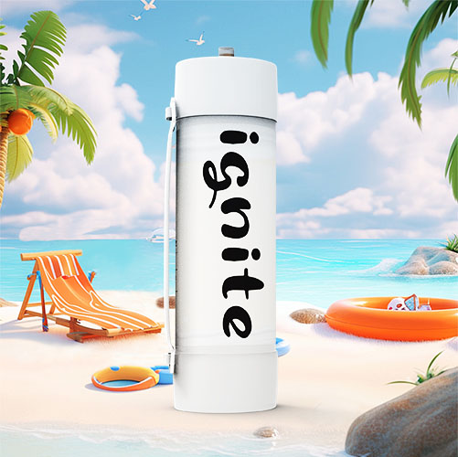 In this image, we see an oversized cream charger canister standing upright on a sandy beach. The canister is white with "ignite" written in a large, bold, black font along its side. The setting is a sunny beach scene with a vibrant blue sky, fluffy white clouds, calm blue waters, and various beach items such as a beach chair, a hat, a beach ball, and an inflatable orange ring. Palm trees are also visible, adding to the tropical vibe. The scene is likely meant to be humorous or attention-grabbing, juxtaposing the ordinary kitchen item with an idyllic beach backdrop.